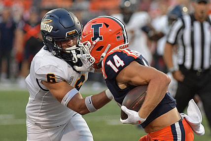 Sep 2, 2023; Champaign, Illinois, USA;  Toledo Rockets safety Nate Bauer (6) tries to tackle Illinois Fighting Illini wide receiver Casey Washington (14) during the first half at Memorial Stadium. Mandatory Credit: Ron Johnson-USA TODAY Sports