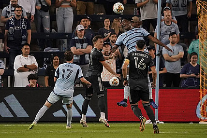 Sep 23, 2023; Kansas City, Kansas, USA; Sporting Kansas City defender Dany Rosero (5) and Houston Dynamo forward Corey Baird (11) go up for a header during the second half at Children's Mercy Park. Mandatory Credit: Denny Medley-USA TODAY Sports