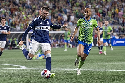 Oct 7, 2023; Seattle, Washington, USA; Vancouver Whitecaps defender Tristan Blackmon (6) passes the ball against Seattle Sounders forward Heber (19) during the second half at Lumen Field. Mandatory Credit: Stephen Brashear-USA TODAY Sports