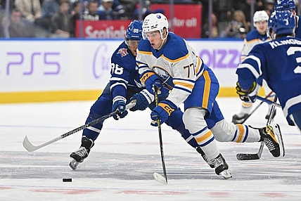 Nov 4, 2023; Toronto, Ontario, CAN;  lBuffalo Sabres forward JJ Peterka (77) skates with the puck past Toronto Maple Leafs forward William Nylander (88) in the second period at Scotiabank Arena. Mandatory Credit: Dan Hamilton-USA TODAY Sports