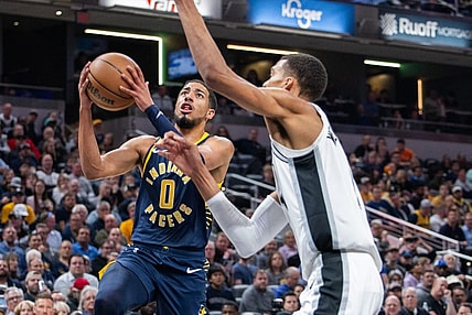 Nov 6, 2023; Indianapolis, Indiana, USA; Indiana Pacers guard Tyrese Haliburton (0)  shoots the ball while San Antonio Spurs center Victor Wembanyama (1) defends in the first half at Gainbridge Fieldhouse. Mandatory Credit: Trevor Ruszkowski-USA TODAY Sports