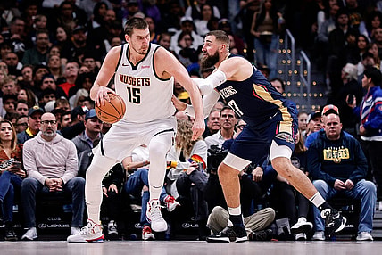 Nov 6, 2023; Denver, Colorado, USA; Denver Nuggets center Nikola Jokic (15) controls the ball as New Orleans Pelicans center Jonas Valanciunas (17) guards in the second quarter at Ball Arena. Mandatory Credit: Isaiah J. Downing-USA TODAY Sports