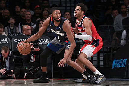 Nov 12, 2023; Brooklyn, New York, USA; Brooklyn Nets forward Mikal Bridges (1) dribbles against Washington Wizards guard Jordan Poole (13) during the second half at Barclays Center. Mandatory Credit: Vincent Carchietta-USA TODAY Sports