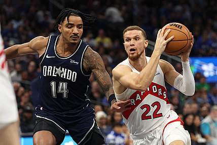 Nov 21, 2023; Orlando, Florida, USA;Toronto Raptors guard Malachi Flynn (22) drives to the basket as Orlando Magic guard Gary Harris (14) defends  during the second half at Amway Center. Mandatory Credit: Kim Klement Neitzel-USA TODAY Sports