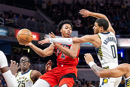 Nov 22, 2023; Indianapolis, Indiana, USA; Toronto Raptors forward Scottie Barnes (4) passes the ball while Indiana Pacers guard Tyrese Haliburton (0) defends in the first half at Gainbridge Fieldhouse. Mandatory Credit: Trevor Ruszkowski-USA TODAY Sports
