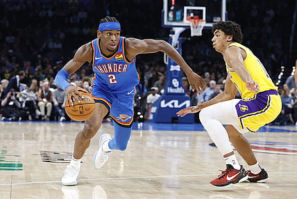 Nov 30, 2023; Oklahoma City, Oklahoma, USA; Oklahoma City Thunder guard Shai Gilgeous-Alexander (2) drives around Los Angeles Lakers guard Max Christie (10) during the second half at Paycom Center. Mandatory Credit: Alonzo Adams-USA TODAY Sports