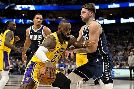 Dec 12, 2023; Dallas, Texas, USA; Los Angeles Lakers forward LeBron James (23) looks to move the ball past Dallas Mavericks guard Luka Doncic (77) during the second quarter at the American Airlines Center. Mandatory Credit: Jerome Miron-USA TODAY Sports