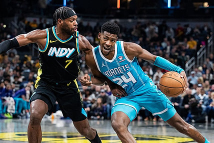 Dec 20, 2023; Indianapolis, Indiana, USA; Charlotte Hornets forward Brandon Miller (24) dribbles the ball while Indiana Pacers guard Buddy Hield (7) defends in the second quarter at Gainbridge Fieldhouse. Mandatory Credit: Trevor Ruszkowski-USA TODAY Sports