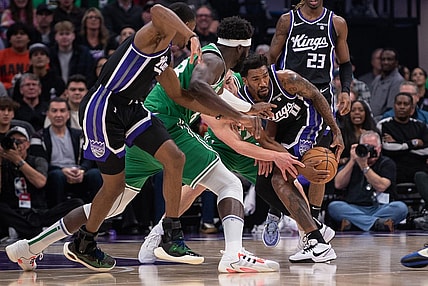 Dec 20, 2023; Sacramento, California, USA; Sacramento Kings guard Malik Monk (0) and Boston Celtics guard Payton Pritchard (11) fight for possession of the ball during the first quarter at Golden 1 Center. Mandatory Credit: Ed Szczepanski-USA TODAY Sports