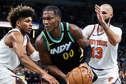 Dec 30, 2023; Indianapolis, Indiana, USA; Indiana Pacers guard Bennedict Mathurin (00) moves to shoot the ball whileNew York Knicks guard Miles McBride (2) and guard Evan Fournier (13)  defend in the second quarter at Gainbridge Fieldhouse. Mandatory Credit: Trevor Ruszkowski-USA TODAY Sports