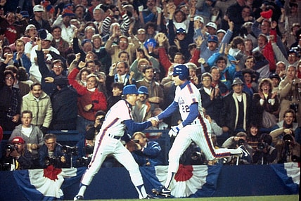 Mets Ray Knight is congratulated by third base coach Bud Harrelson after his 7th inning home run off Boston's Calvin Schiraldi broke a 3-3 tie during Game 7 of the World Series at Shea Stadium Oct. 27, 1986.

Mets Vs Red Sox 1986 World Series