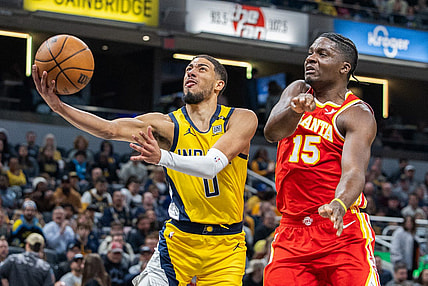 Jan 5, 2024; Indianapolis, Indiana, USA; Indiana Pacers guard Tyrese Haliburton (0) shoots the ball while Atlanta Hawks center Clint Capela (15) defends in the first quarter at Gainbridge Fieldhouse. Mandatory Credit: Trevor Ruszkowski-USA TODAY Sports