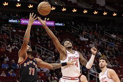 Feb 2, 2024; Houston, Texas, USA; Toronto Raptors forward Bruce Brown (11) and Houston Rockets guard Jalen Green (4) reach for a rebound in the first quarter at Toyota Center. Mandatory Credit: Thomas Shea-USA TODAY Sports