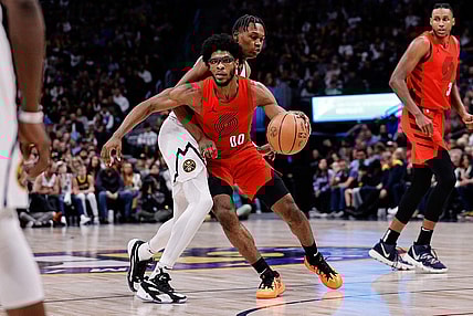 Feb 4, 2024; Denver, Colorado, USA; Portland Trail Blazers guard Scoot Henderson (00) controls the ball as Denver Nuggets forward Peyton Watson (8) guards in the third quarter at Ball Arena. Mandatory Credit: Isaiah J. Downing-USA TODAY Sports