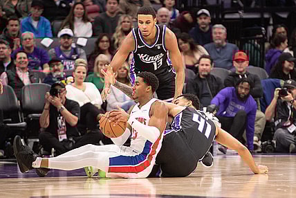 Feb 7, 2024; Sacramento, California, USA; Detroit Pistons guard Jaden Ivey (23) and Sacramento Kings forward Trey Lyles (41) fight for possession of the ball during the second quarter at Golden 1 Center. Mandatory Credit: Ed Szczepanski-USA TODAY Sports