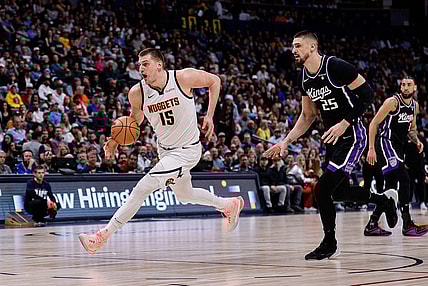 Feb 28, 2024; Denver, Colorado, USA; Denver Nuggets center Nikola Jokic (15) controls the ball ahead of Sacramento Kings center Alex Len (25) in the first quarter at Ball Arena. Mandatory Credit: Isaiah J. Downing-USA TODAY Sports