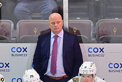 Jan 9, 2024; Tempe, Arizona, USA; Boston Bruins head coach Jim Montgomery looks on in the first period against the Arizona Coyotes at Mullett Arena. Mandatory Credit: Matt Kartozian-USA TODAY Sports
