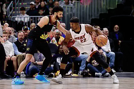 Feb 29, 2024; Denver, Colorado, USA; Miami Heat forward Jimmy Butler (22) controls the ball as Denver Nuggets guard Jamal Murray (27) guards in the first quarter at Ball Arena. Mandatory Credit: Isaiah J. Downing-USA TODAY Sports