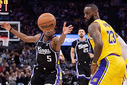 Mar 13, 2024; Sacramento, California, USA; Sacramento Kings guard De'Aaron Fox (5) and Los Angeles Lakers forward LeBron James (23) go for the loose ball during the second quarter at Golden 1 Center. Mandatory Credit: Ed Szczepanski-USA TODAY Sports
