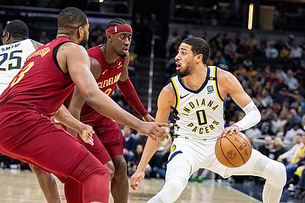 Mar 18, 2024; Indianapolis, Indiana, USA; Indiana Pacers guard Tyrese Haliburton (0) dribbles the ball while Cleveland Cavaliers guard Caris LeVert (3) defends in the first half at Gainbridge Fieldhouse. Mandatory Credit: Trevor Ruszkowski-USA TODAY Sports