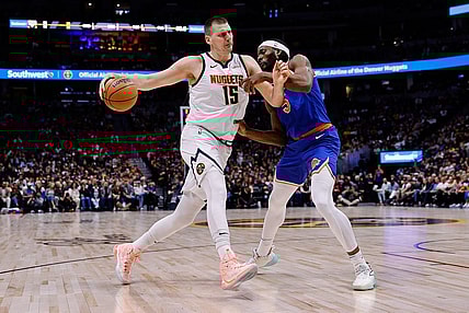 Mar 21, 2024; Denver, Colorado, USA; Denver Nuggets center Nikola Jokic (15) controls the ball as New York Knicks forward Precious Achiuwa (5) guards in the first quarter at Ball Arena. Mandatory Credit: Isaiah J. Downing-USA TODAY Sports