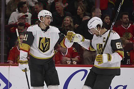 Vegas Golden Knights center Brett Howden (21) celebrates with right wing Mark Stone (61) after scoring an empty-net goal during the third period of an NHL hockey game against the Chicago Blackhawks, Friday, March 28, 2025, in Chicago. (AP Photo/Melissa Tamez)