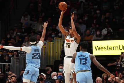 Jan 21, 2022; Denver, Colorado, USA; Denver Nuggets forward Zeke Nnaji (22) shoots over Memphis Grizzlies guard Jarrett Culver (23) and forward Jaren Jackson Jr. (13) in the second quarter at Ball Arena. Mandatory Credit: Ron Chenoy-USA TODAY Sports