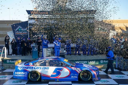 Oct 24, 2021; Kansas City, Kansas, USA; NASCAR Cup Series driver Kyle Larson (5) celebrates with his crew after winning the Hollywood Casino 400 at Kansas Speedway. Mandatory Credit: Denny Medley-USA TODAY Sports