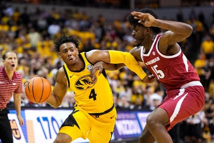 Jan 18, 2023; Columbia, Missouri, USA; Missouri Tigers guard DeAndre Gholston (4) drives against Arkansas Razorbacks forward Makhi Mitchell (15) during the first half at Mizzou Arena. Mandatory Credit: Jay Biggerstaff-USA TODAY Sports