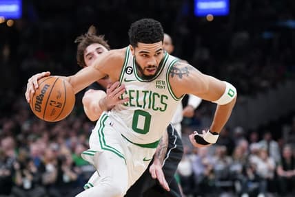 Feb 1, 2023; Boston, Massachusetts, USA; Boston Celtics forward Jayson Tatum (0) drives the ball against Brooklyn Nets forward Joe Harris (12) in the first quarter at TD Garden. Mandatory Credit: David Butler II-USA TODAY Sports