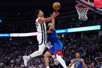 Mar 3, 2023; Denver, Colorado, USA;Memphis Grizzlies guard Desmond Bane (22) drives to the basket against Denver Nuggets guard Jamal Murray (27) during the second quarter at Ball Arena. Mandatory Credit: Ron Chenoy-USA TODAY Sports