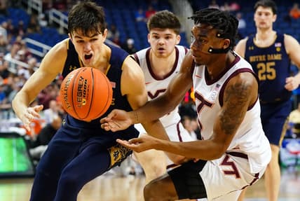 Mar 7, 2023; Greensboro, NC, USA; Notre Dame Fighting Irish guard Cormac Ryan (5) battles for a loose ball with Virginia Tech Hokies guard MJ Collins (2) during the second half of the first round of the ACC tournament at Greensboro Coliseum. Mandatory Credit: John David Mercer-USA TODAY Sports