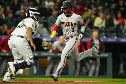 Apr 28, 2023; Denver, Colorado, USA; Arizona Diamondbacks shortstop Geraldo Perdomo (2) scores a run in front of Colorado Rockies catcher Elias Diaz (35) in the seventh inning at Coors Field. Mandatory Credit: Ron Chenoy-USA TODAY Sports