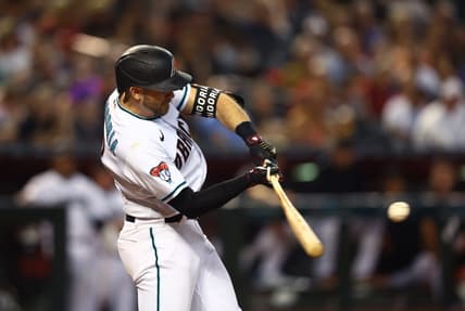 Jun 27, 2023; Phoenix, Arizona, USA; Arizona Diamondbacks infielder Evan Longoria hits a solo home run in the third inning against the Tampa Bay Rays at Chase Field. Mandatory Credit: Mark J. Rebilas-USA TODAY Sports