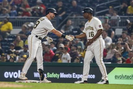Jun 28, 2023; Pittsburgh, Pennsylvania, USA;  Pittsburgh Pirates third baseman Jared Triolo (19) celebrates his first major league hit with first base coach Tarrik Brock (16) against the San Diego Padres during the eighth inning at PNC Park. Pittsburgh won 7-1. Mandatory Credit: Charles LeClaire-USA TODAY Sports