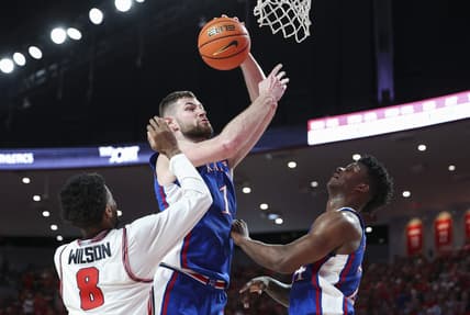 Mar 9, 2024; Houston, Texas, USA; Kansas Jayhawks center Hunter Dickinson (1) attempts to score as Houston Cougars guard Mylik Wilson (8) defends during the first half at Fertitta Center. Mandatory Credit: Troy Taormina-USA TODAY Sports