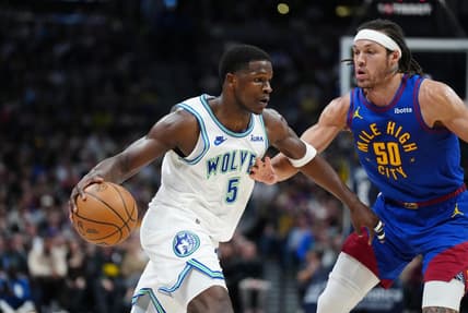 Mar 29, 2024; Denver, Colorado, USA; Minnesota Timberwolves guard Anthony Edwards (5) drives at Denver Nuggets forward Aaron Gordon (50) in the second quarter at Ball Arena. Mandatory Credit: Ron Chenoy-USA TODAY Sports