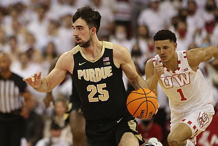 Mar 1, 2022; Madison, Wisconsin, USA; Purdue Boilermakers guard Ethan Morton (25) brings the ball up the floor as Wisconsin Badgers guard Johnny Davis (1) follows during the first half at the Kohl Center. Mandatory Credit: Mary Langenfeld-USA TODAY Sports