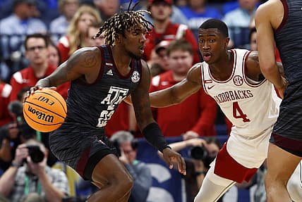 Mar 12, 2022; Tampa, FL, USA; Texas A&M Aggies guard Tyrece Radford (23) drives to the basket as Arkansas Razorbacks guard Davonte Davis (4) defends during the first half at Amalie Arena. Mandatory Credit: Kim Klement-USA TODAY Sports