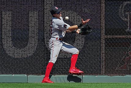 Aug 7, 2022; Kansas City, Missouri, USA; Boston Red Sox center fielder Jarren Duran (40) is unable to make the catch at the wall during the eighth inning against the Kansas City Royals at Kauffman Stadium. Mandatory Credit: Jay Biggerstaff-USA TODAY Sports
