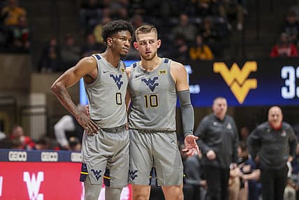 Dec 22, 2022; Morgantown, West Virginia, USA; West Virginia Mountaineers guard Erik Stevenson (10) talks with West Virginia Mountaineers guard Kedrian Johnson (0) during the second half against the Stony Brook Seawolves at WVU Coliseum. Mandatory Credit: Ben Queen-USA TODAY Sports