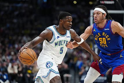 Mar 29, 2024; Denver, Colorado, USA; Minnesota Timberwolves guard Anthony Edwards (5) drives at Denver Nuggets forward Aaron Gordon (50) in the second quarter at Ball Arena. Mandatory Credit: Ron Chenoy-USA TODAY Sports