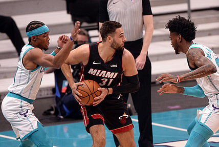 May 2, 2021; Charlotte, North Carolina, USA;  Miami Heat guard Max Strus (31) looks to pass as he is defended by Charlotte Hornets guard Devonte  Graham (4) and forward Jalen McDaniels (4) during the first half at the Spectrum Center. Mandatory Credit: Sam Sharpe-USA TODAY Sports