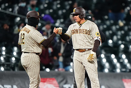 May 11, 2021; Denver, Colorado, USA; San Diego Padres third baseman Manny Machado (13) celebrates his three run triple with third base coach Bobby Dickerson (12) in the sixth inning against the Colorado Rockies at Coors Field. Mandatory Credit: Ron Chenoy-USA TODAY Sports