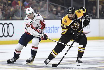 Sep 16, 2018; Boston, MA, USA; Boston Bruins center David Krejci (46) skates with the puck against Washington Capitals forward Garrett Pilon (40) during the third period at TD Garden. Mandatory Credit: Bob DeChiara-USA TODAY Sports