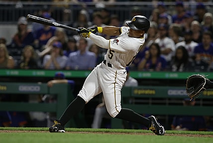 Jul 17, 2021; Pittsburgh, Pennsylvania, USA;  Pittsburgh Pirates pinch hitter Wilmer Difo (15) hits a three run pinch hit home run against the New York Mets during the eighth inning at PNC Park. Mandatory Credit: Charles LeClaire-USA TODAY Sports