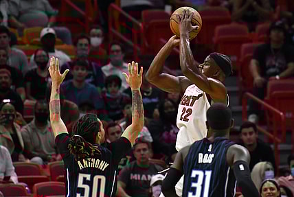 Oct 25, 2021; Miami, Florida, USA; Miami Heat forward Jimmy Butler (22) shoots the ball over Orlando Magic guards Cole Anthony (50) and Terrence Ross (31) during the first half at FTX Arena. Mandatory Credit: Jim Rassol-USA TODAY Sports