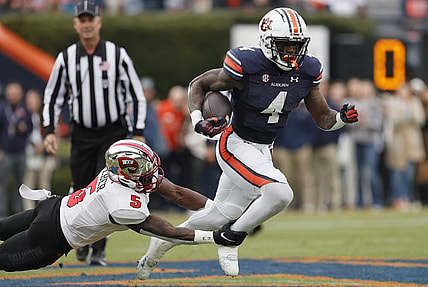 Nov 19, 2022; Auburn, Alabama, USA; Western Kentucky Hilltoppers defensive back Rome Weber (5) grabs Auburn Tigers running back Tank Bigsby (4) during the first quarter at Jordan-Hare Stadium. Mandatory Credit: John Reed-USA TODAY Sports