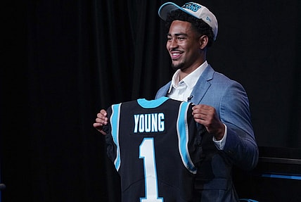Apr 28, 2023; Charlotte, NC, USA; Bryce Young holds up a jersey depicting his draft position at Bank of America Stadium. Mandatory Credit: Jim Dedmon-USA TODAY Sports