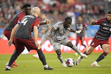 Aug 20, 2023; Toronto, Ontario, CAN; CF Montr  al forward Kwadwo Opoku (90) controls the ball while defended by several Toronto FC players during the first half at BMO Field. Mandatory Credit: John E. Sokolowski-USA TODAY Sports